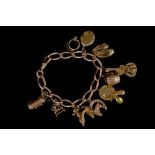 A 9CT GOLD CHARM BRACELET,