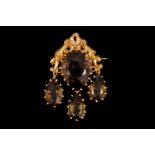 AN ANTIQUE SMOKY TOPAZ BROOCH, the pear shaped topaz suspending three topaz drops,