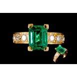 AN EMERALD AND DIAMOND RING, one emerald cut emerald of approx. 2.