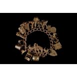 A 9CT GOLD CHARM BRACELET,