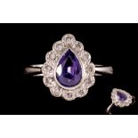 AN AMETHYST AND DIAMOND CLUSTER RING, the pear shaped amethyst to a brilliant cut diamond surround,