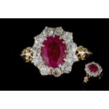 A RUBY AND DIAMOND CLUSTER RING, one oval cut ruby of approx. 1.