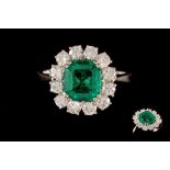 AN EMERALD AND DIAMOND CLUSTER RING, with one emerald of 2.