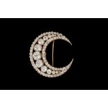 A VICTORIAN CLOSED CRESCENT BROOCH, set throughout with old cut diamonds of approx. 16.