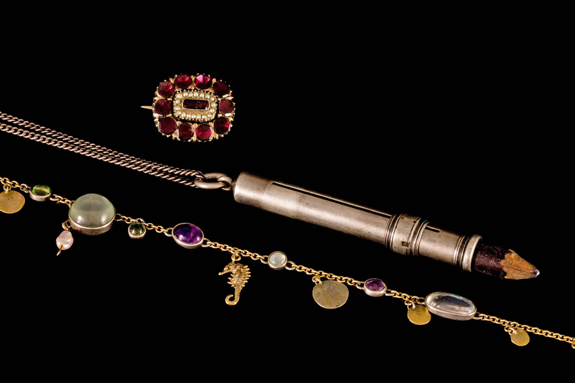 A SILVER PENCIL, London 1922, with chain; together with a moonstone and amethyst necklace, on gold,