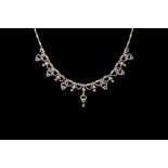 A DIAMOND FANCY FRINGE NECKLACE, with diamond floral motif drops and diamond set swags, of approx.