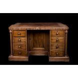 A LATE VICTORIAN MAHOGANY VENEERED DESK, with fitted drawers,