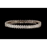 A DIAMOND BANGLE, set throughout with marquise brilliant cut diamonds of approx. 20.