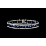 AN ART DECO SAPPHIRE AND DIAMOND BRACELET, set throughout with French cut sapphires of approx 19.
