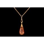 A POLISHED AMBER PENDANT, 18ct gold mount,