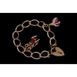 A 9CT GOLD CHARM BRACELET, set with eleven charms