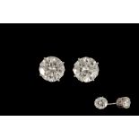 A PAIR OF DIAMOND SOLITAIRE STUD EARRINGS, with two round brilliant cut diamonds of approx. 2.