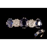 A SAPPHIRE AND DIAMOND FIVE STONE RING, with cushion cut sapphires of approx 2.