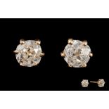 A PAIR OF DIAMOND SOLITAIRE STUD EARRINGS, with two old mine cut diamonds of approx 2.