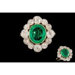 AN EMERALD AND DIAMOND OVAL CLUSTER RING, with one oval cut fine Colombian emerald of 2.