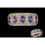 A TANZANITE AND DIAMOND DRESS RING, with tanzanites of approx. 1.50ct in total, diamonds of approx.