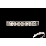 A DIAMOND SEVEN STONE RING,