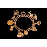 A 9CT GOLD CHARM BRACELET,