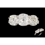 A DIAMOND THREE STONE RING, three cushion shape old brilliant cut diamonds of approx. 4.