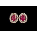 A PAIR OF RUBY AND DIAMOND CLUSTER EARRINGS