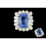 A SAPPHIRE AND DIAMOND CLUSTER RING, one cushion cut sapphire of 9.