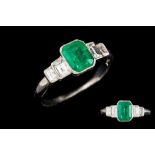 AN EMERALD AND DIAMOND RING, a central emerald of 0.86ct with baguette cut diamonds of approx.0.