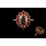 A GARNET CLUSTER RING,