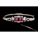 A RUBY AND DIAMOND COCKTAIL BRACELET, with three oval cut rubies of 2.