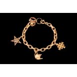 AN 18CT GOLD CHARM BRACELET,