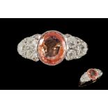 A PADPARADSCHA SAPPHIRE AND DIAMOND DRESS RING, one oval padparadscha sapphire of 3.