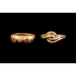 AN 18CT WHITE AND YELLOW GOLD KNOT RING; together with an antique ruby and diamond three stone ring,