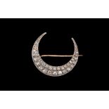 A VICTORIAN DIAMOND CLOSED CRESCENT BROOCH, set throughout with rose cut diamonds.