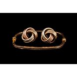 A 9CT GOLD CUSHION SHAPED BANGLE;