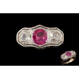 A RUBY AND DIAMOND THREE STONE RING, mounted on 18ct yellow gold,