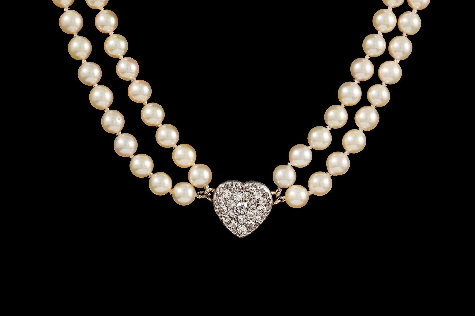 A CULTURED PEARL NECKLACE, two row uniform necklace with diamond pavé heart shape pendant.