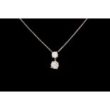 A TWO STONE DIAMOND PENDANT AND CHAIN, with one old European brilliant cut diamond of approx 1.