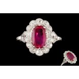 A RUBY AND DIAMOND OVAL CLUSTER RING, with one oval cut ruby of 1.