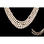 A FOUR STRANDED GRADUATED PEARL NECKLACE, strung to an old cut diamond clasp,