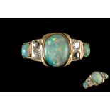 AN OPAL AND DIAMOND DRESS RING, with diamonds of approx. 0.56ct, mounted in 18ct gold.