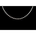 A DIAMOND LINE NECKLACE, signed Cartier, set throughout with diamonds of approx. 9.