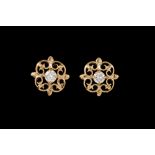 A PAIR OF DIAMOND STUD EARRINGS, scrolled gold surrounds,