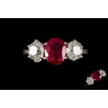 A RUBY AND DIAMOND THREE STONE RING, one cushion cut ruby of 2.