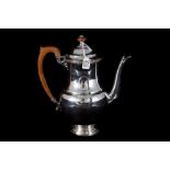 A PRE-WAR SILVER COFFEE POT, of plain baluster form, London 1930, by Goldsmith & Silversmith,