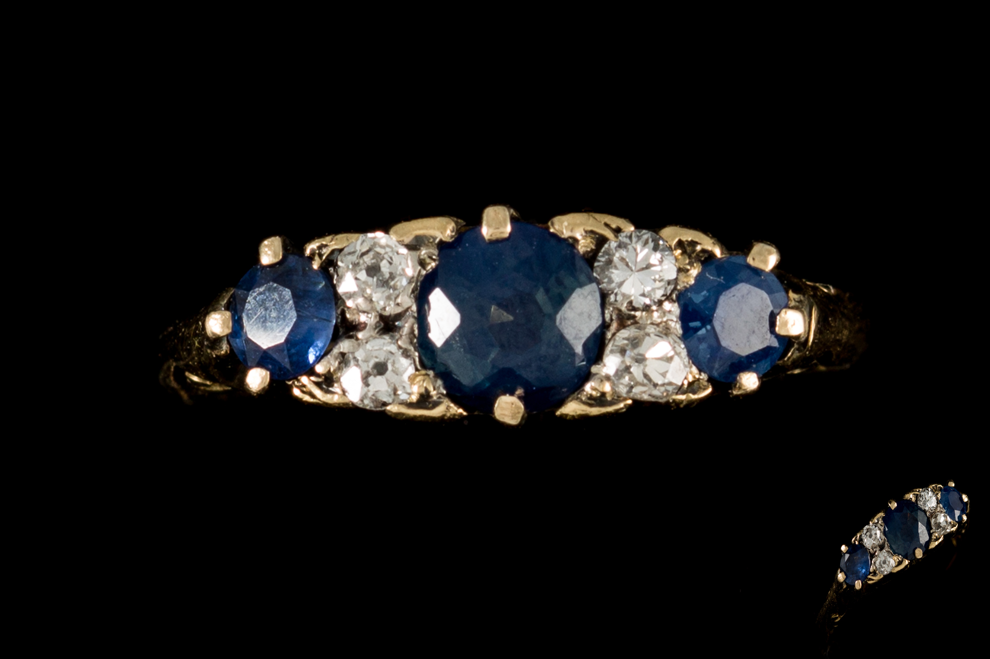 A LATE VICTORIAN SAPPHIRE AND DIAMOND CARVED DRESS RING, with sapphires of approx. 1.