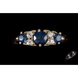 A LATE VICTORIAN SAPPHIRE AND DIAMOND CARVED DRESS RING, with sapphires of approx. 1.