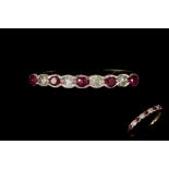 A DIAMOND AND RUBY HALF ETERNITY RING,