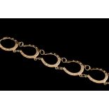 A GOLD EQUINE BRACELET,