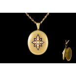 AN OVAL LOCKET AND CHAIN,