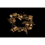 A GOLD CHARM BRACELET, with various charms,