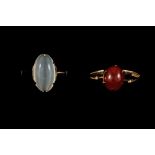 A CARNELIAN RING, together with a moonstone ring,